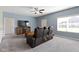 Cozy living room with large window, ceiling fan, and comfortable seating at 6524 Turf Way, Anderson, IN 46013