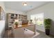 Well-lit home office with built-in bookshelves and a large window at 6524 Turf Way, Anderson, IN 46013