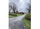 Charming brick ranch home featuring a long driveway and mature trees on a spacious lot at 6835 W Us Highway 36, Danville, IN 46122