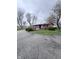 Quaint single-story home with a charming brick and siding exterior, surrounded by mature trees and landscaping at 6835 W Us Highway 36, Danville, IN 46122