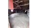 Spacious garage with exposed wooden rafters and beams, and a concrete floor at 6835 W Us Highway 36, Danville, IN 46122