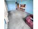A cozy living area with blue walls, carpet, an eat in bar area, and open floor plan at 6835 W Us Highway 36, Danville, IN 46122
