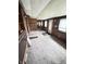 Cozy living room with wood paneled walls, carpet floors, and steps leading to an open area at 6835 W Us Highway 36, Danville, IN 46122