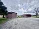 Property featuring multiple storage buildings with mature trees on a cloudy day at 6835 W Us Highway 36, Danville, IN 46122
