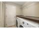 Convenient laundry area equipped with washer, dryer, shelving, and storage space at 7951 Busby Bend Dr, Noblesville, IN 46062