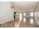 Spacious living room with an open concept, modern lighting, and wood-look flooring at 7951 Busby Bend Dr, Noblesville, IN 46062