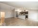 Open concept living space with modern lighting, kitchen access, and decorative arrow at 7951 Busby Bend Dr, Noblesville, IN 46062