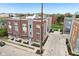 An aerial view of modern townhomes with brick and siding exteriors, complemented by lush landscaping at 801 Bates St, Indianapolis, IN 46202