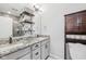 Well-lit bathroom with granite countertops, double sinks, and modern fixtures at 801 Bates St, Indianapolis, IN 46202