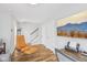 Versatile bonus room features an orange lounge chair, office desk setup, and stairs to the main floor at 801 Bates St, Indianapolis, IN 46202