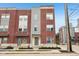 Beautiful multi-level townhome featuring brick facade, modern gray accents, and well-maintained landscaping at 801 Bates St, Indianapolis, IN 46202