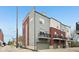 Modern townhome exterior showcasing brick and siding accents with a private garage and small balcony at 801 Bates St, Indianapolis, IN 46202