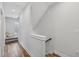 Hallway with sleek flooring leads to the staircase, providing access to upper and lower floors at 801 Bates St, Indianapolis, IN 46202