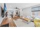 Bright living area offering open floor plan, hardwood floors, ceiling fan, and barstool seating at island at 801 Bates St, Indianapolis, IN 46202