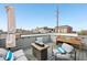 Charming rooftop deck with comfortable seating, a fire pit, and city views at 801 Bates St, Indianapolis, IN 46202
