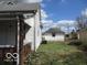 Exterior side view showcasing a detached garage, grassy yard, and the side of the house at 909 S Colfax St, Martinsville, IN 46151