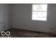 Bedroom with a window letting in natural light and neutral carpeting at 909 S Colfax St, Martinsville, IN 46151