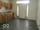 Kitchen featuring laminate countertops, wooden cabinets, and a door with glass panels at 909 S Colfax St, Martinsville, IN 46151