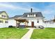 Backyard features a lawn, hot tub, and seating area, making it perfect for relaxing and entertaining guests at 1015 Main St, Elwood, IN 46036