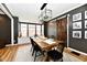 Elegant dining room boasts a stylish wooden table, modern light fixture, and rustic sliding barn door at 1015 Main St, Elwood, IN 46036