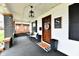 Inviting front porch featuring stylish seating, a dark door, and elegant decor for a welcoming entrance at 1015 Main St, Elwood, IN 46036