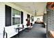 Charming front porch with cozy seating, string lights, and a view of the neighborhood creating a relaxing space at 1015 Main St, Elwood, IN 46036