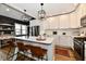 Modern kitchen featuring white cabinets, stainless steel appliances, and an island with bar seating at 1015 Main St, Elwood, IN 46036