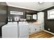 Functional laundry room with modern washer/dryer units and ample storage space at 1015 Main St, Elwood, IN 46036