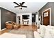 Stylish living room boasts a comfortable sectional sofa, modern ceiling fan, and elegant decor for relaxation at 1015 Main St, Elwood, IN 46036