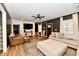 Inviting living room features a large sectional sofa, sleek ceiling fan, and warm wood flooring for relaxation at 1015 Main St, Elwood, IN 46036
