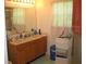 Well-lit bathroom featuring double sinks, vanity and window at 10762 Galant Fox Ct, Indianapolis, IN 46234