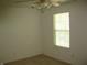Well-lit bedroom features a ceiling fan, a window with blinds, and neutral carpeting at 10762 Galant Fox Ct, Indianapolis, IN 46234