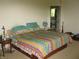 Bedroom featuring a colorful bed and view into bathroom at 10762 Galant Fox Ct, Indianapolis, IN 46234