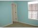 Cozy bedroom featuring an inviting window, light-blue painted walls, and neutral carpeting at 10762 Galant Fox Ct, Indianapolis, IN 46234