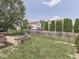 Well-manicured backyard with patio and seating area surrounded by lush lawn at 1228 Easton Point Dr, Greenwood, IN 46142