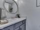 Stylish half bathroom with modern fixtures, round mirror, and decorative accessories for added elegance and charm at 1228 Easton Point Dr, Greenwood, IN 46142