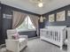 Charming Bedroom with a crib, comfortable chair, and soft natural light at 1228 Easton Point Dr, Greenwood, IN 46142
