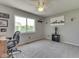 Well-lit bedroom featuring a ceiling fan, large window, and dedicated desk workspace at 1228 Easton Point Dr, Greenwood, IN 46142