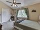 Cozy bedroom featuring a ceiling fan, natural light, and neutral décor at 1228 Easton Point Dr, Greenwood, IN 46142