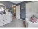 Bright bedroom with a chair and a view into the bathroom at 1228 Easton Point Dr, Greenwood, IN 46142