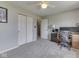 Bright bedroom with a ceiling fan, double closets, and a workspace at 1228 Easton Point Dr, Greenwood, IN 46142