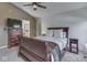Comfortable bedroom featuring a ceiling fan, hardwood furnishings, and an en suite bathroom at 1228 Easton Point Dr, Greenwood, IN 46142