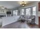 Bright breakfast nook with bay window seating adjacent to the living room and kitchen with hardwood floors at 1228 Easton Point Dr, Greenwood, IN 46142