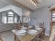 Inviting dining area with table set for six, open to living room and stairway with contemporary lighting fixture at 1228 Easton Point Dr, Greenwood, IN 46142