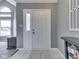 Welcoming entryway with light tile flooring, gray walls, and a bright front door at 1228 Easton Point Dr, Greenwood, IN 46142