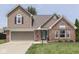 Charming two-story home with a well-manicured lawn and beautiful brick and siding accents at 1228 Easton Point Dr, Greenwood, IN 46142