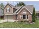 Lovely two-story home featuring brick and siding accents, an attached garage, and well-kept landscaping at 1228 Easton Point Dr, Greenwood, IN 46142