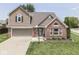 Beautiful two-story home with brick and siding, an attached garage, and a green lawn at 1228 Easton Point Dr, Greenwood, IN 46142