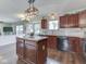 Open-concept kitchen featuring center island, stainless steel appliances, and hardwood floors, open to the living room at 1228 Easton Point Dr, Greenwood, IN 46142
