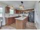 Well-appointed kitchen featuring granite countertops, island, updated appliances, and dark wood cabinetry with foliage at 1228 Easton Point Dr, Greenwood, IN 46142